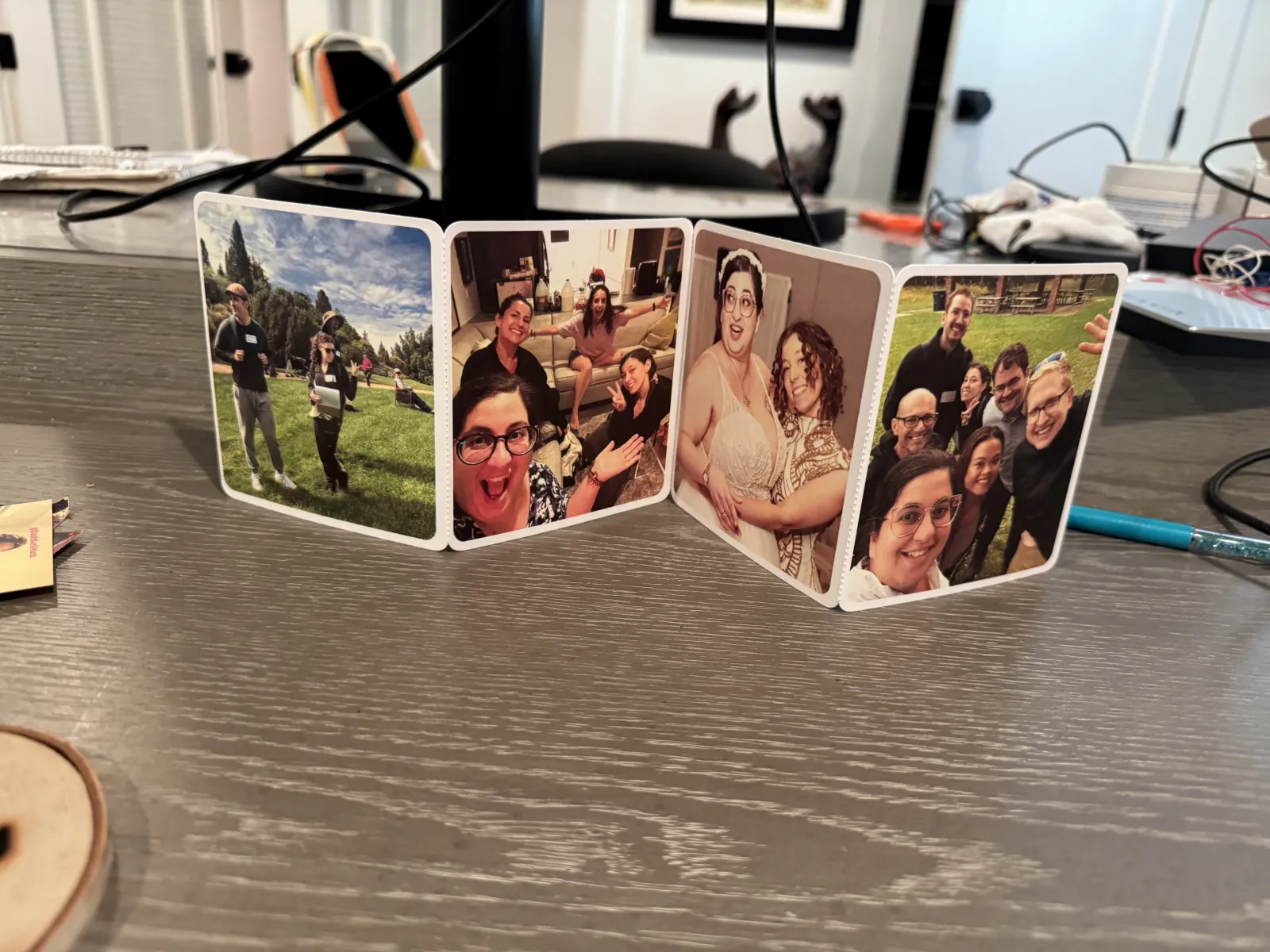 A fold-out Felt card stands open on a desk, displaying photos of friends.